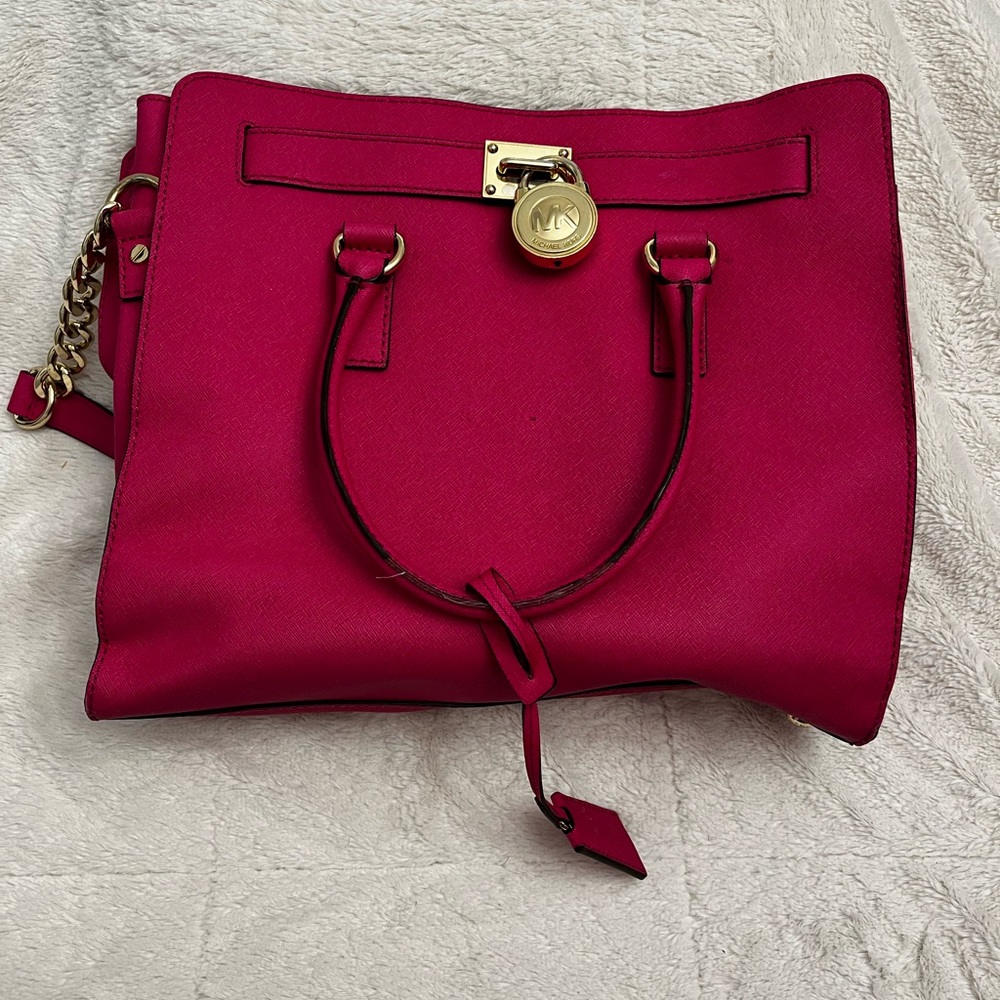 Michael Kors Hamilton Lock Pink Large Tote Leather is in used condition.